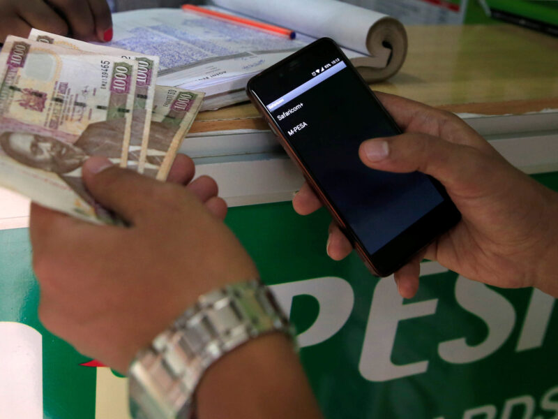 Customer conducts a mobile money transfer at a Safaricom agent stall in Nairobi